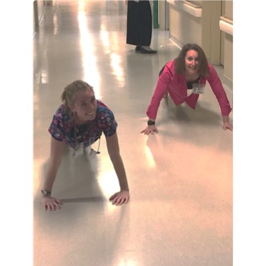 two nurses doing pushups