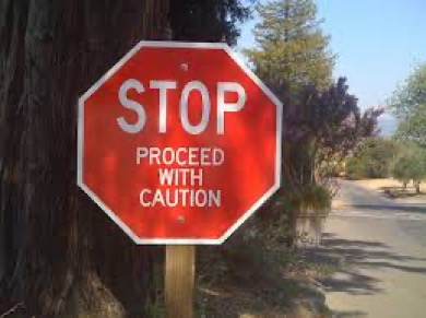 stop sign with proceed with caution on it