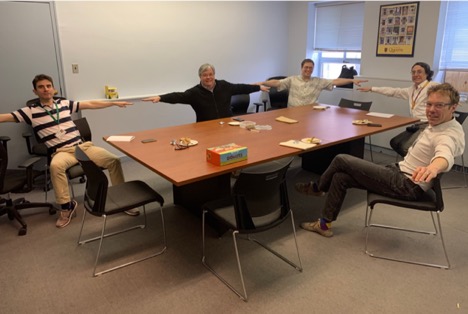 photo of doctors sitting around a table each 2m apart