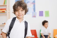 2 school aged boys in a  classroom