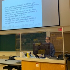 photo of Dr. Beyak presenting at podium with overhead screen behind him