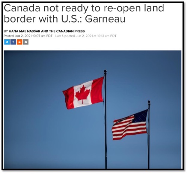 Canada and USA flags on flag poles