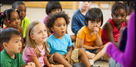 group of young children sitting on floor in classroom