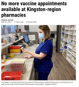 female pharmacy worker in pharmacy looking at pill bottle
