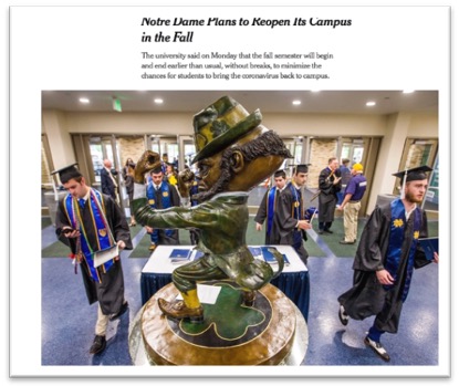 photo of grads around statue of Notre Dame mascot