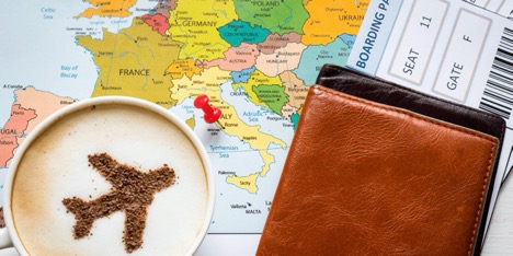 map, boarding pass, latte with cinnamon image of plane and passport holder