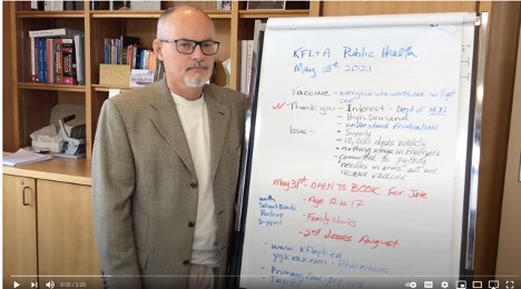 Dr Keiran Moore standing beside a flip chart