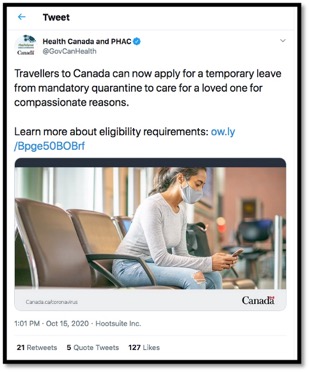 picture of lady with a mask sitting in chair on cell phone