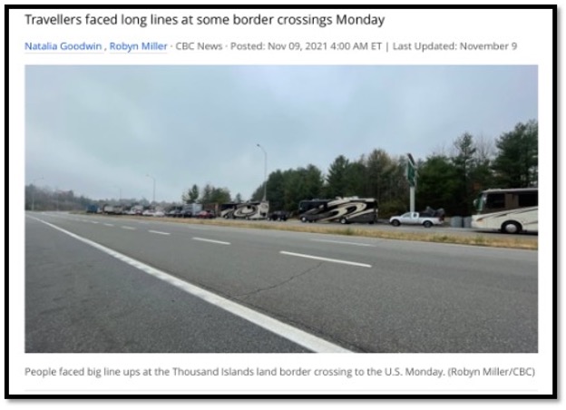 photo of car and campers lined up to cross Canadian US land border