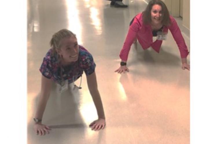 two nurses doing pushups