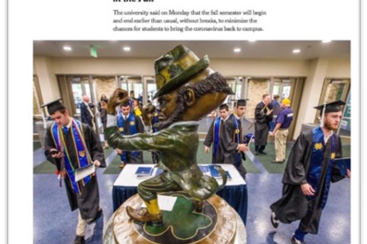 photo of grads around statue of Notre Dame mascot