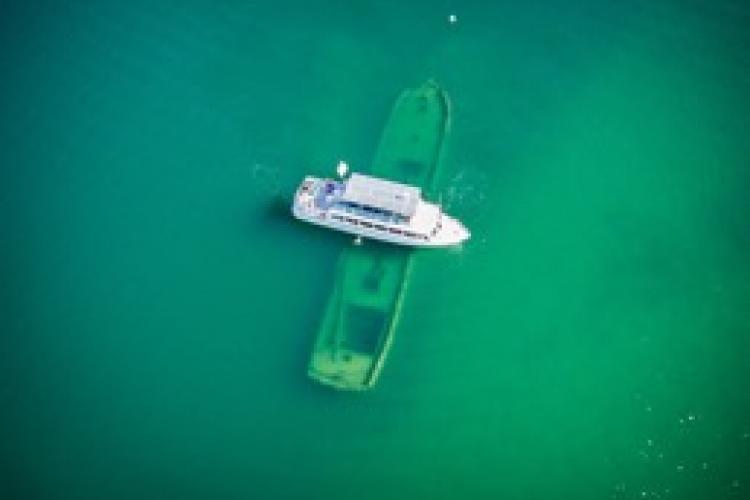Boat floating over a sunken boat
