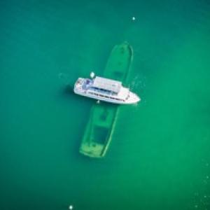 Boat floating over a sunken boat